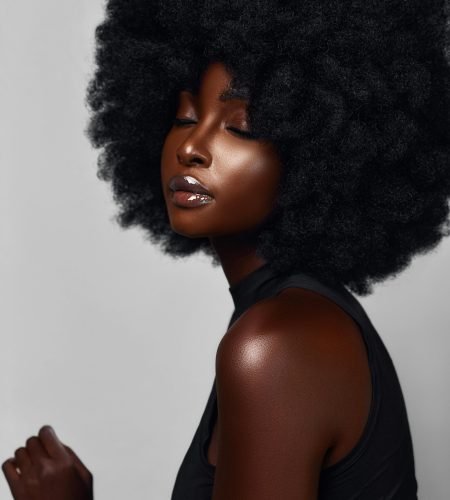 Elegant portrait of a woman with a natural afro hairstyle, showcasing beauty and confidence.